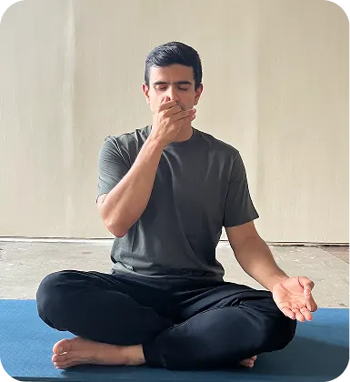 Yoga trainer seated on a mat